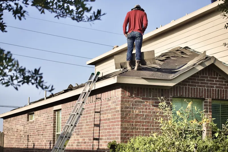 Professional roofer working on a residential roof in Pepperton